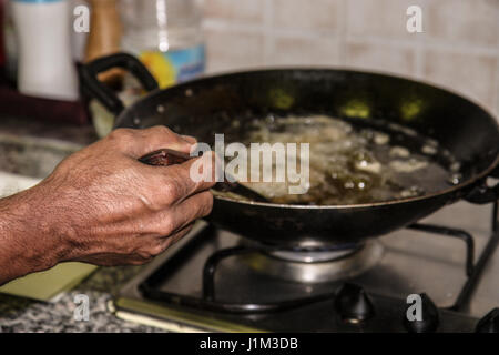 Fish frying in a pan on the oven Stock Photo