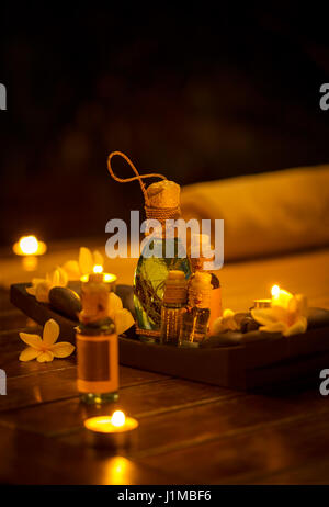 Bottles of massage oil, spa set with candles Stock Photo