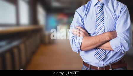 Digital composite of Midsection of businessman with arms crossed standing In office Stock Photo