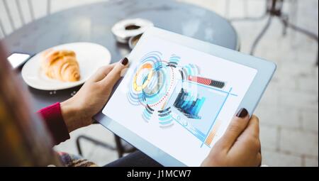 Digital composite of Cropped image of woman using tablet computer with graphs and structure on screen Stock Photo