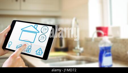 Digital composite of Hands using smart home app on tablet computer in kitchen Stock Photo