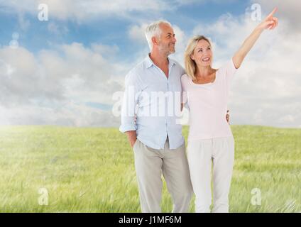 Digital composite of Couple walking in meadow nature Stock Photo