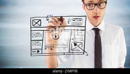 Digital composite of Business man with marker and website mock up against blurry grey wood panel Stock Photo
