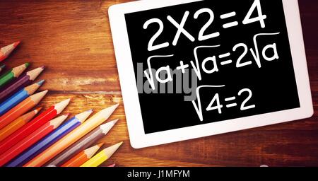 Digital composite of High angle view of various mathematical formula by color pencils on wooden table Stock Photo