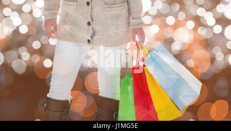 Digital composite of Midsection of woman holding colorful shopping bags Stock Photo
