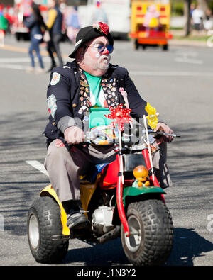 Clown riding  bike during street parade - USA