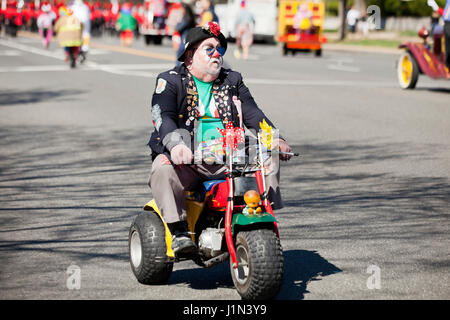 Clown riding  bike during street parade - USA