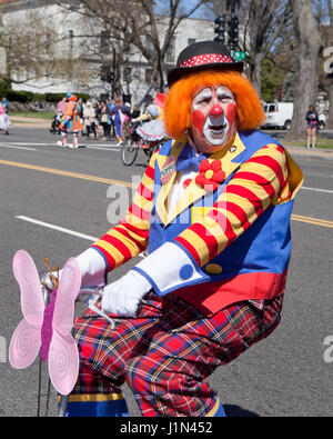 Clown riding  bike during street parade - USA