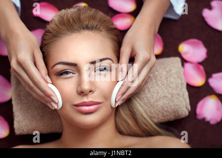 Peaceful brunette getting facial treatment from beauty therapist in the health spa Stock Photo