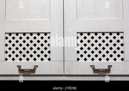 cabinet doors with wooden bars and metal handles in style Stock Photo