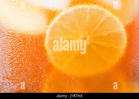Glasses of iced tea with lemon slices,  Water drop on cup, water condensation. Stock Photo
