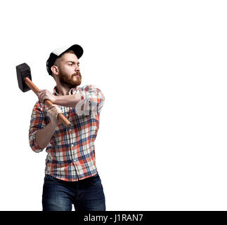 Redhead Bearded man wearing a baseball cap and shirt swunging a hammer with an expression. Stock Photo