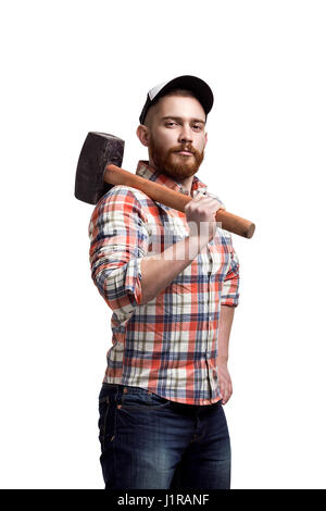 Redhead Bearded man wearing a baseball cap and shirt holding a hammer on a shoulder with an expression. Stock Photo