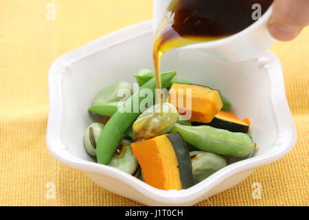 Fresh vegetables mixed with green peas soybean pumpkin and sauce Stock Photo