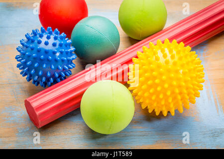 self massage and reflexology therapy concept - a set of small rubber balls and roller bar Stock Photo