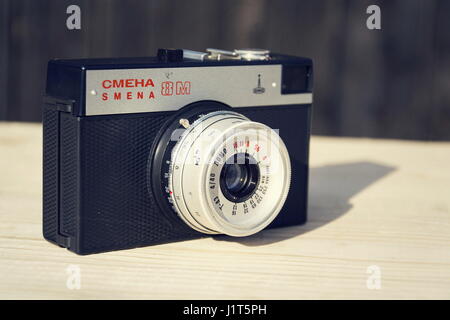 BOROTIN, CZECH REPUBLIC - MARCH 25: Smena 8M old vintage filtered camera on wooden background on March 25, 2017 in Borotin, Czech republic. Stock Photo