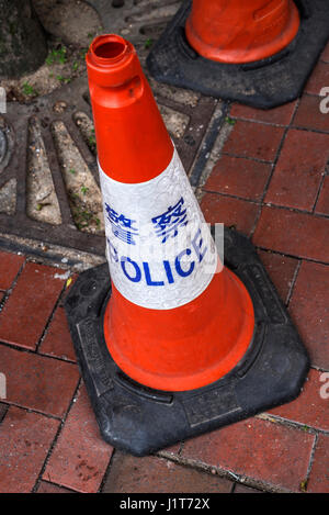 Police Warning Cones in Chinese and English Stock Photo