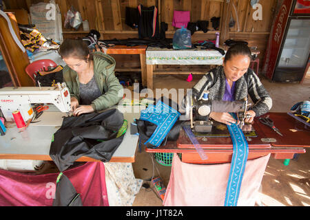 Hmong women making traditional clothes in the town of Phonsavan in the province Xieng Khuang in north Lao in southeastasia. Stock Photo