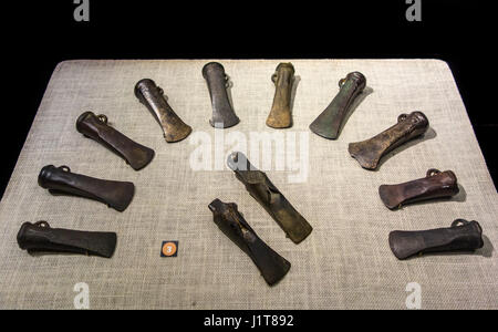 Collection of winged axes and bronze socketed axes, linear facetted axe heads from the Late Bronze Age Stock Photo
