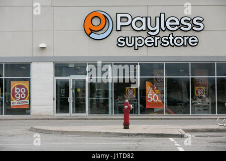 A logo sign outside of a Payless ShoeSource retail store in Mississauga, Ontario, Canada, on April 16, 2017. Stock Photo