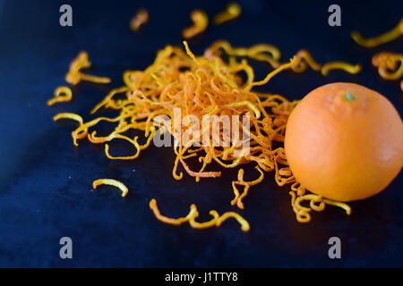 Fresh mandari zest with full fruits on a dark blue abstract background. Selective focus. Stock Photo