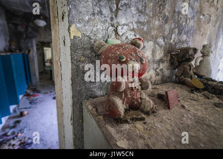 Old toys in 'Cheburashka' kindergarten No 10 in Pripyat ghost city, Chernobyl Nuclear Power Plant Zone of Alienation in Ukraine Stock Photo