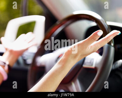 female driver demonstrating auto driving. Stock Photo