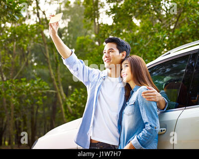 young asian couple taking a selfie during a trip. Stock Photo