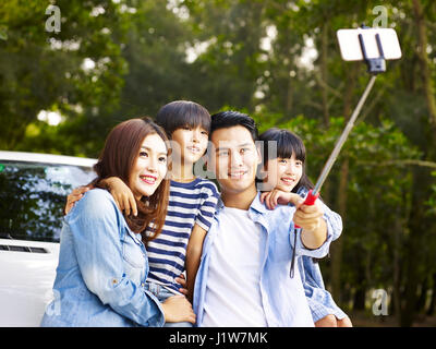 asian family with two children taking a selfie during a trip. Stock Photo