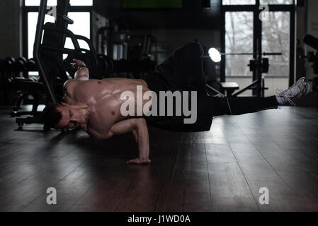 Young Man Athlete Doing Extreme Handstand On One Hand As Part Of Bodybuilding Training Stock Photo