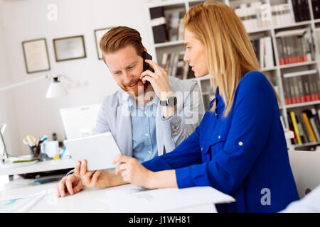 Smart coworkers sharing ideas in office Stock Photo