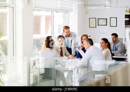 Businesspeople collaborating and talking through new ideas in office Stock Photo