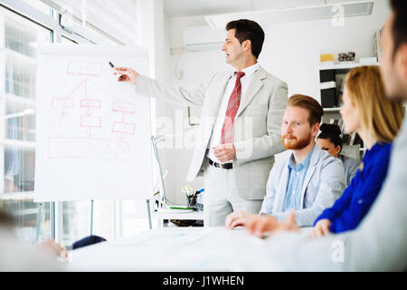 Business people in office holding a conference and discussing strategies Stock Photo
