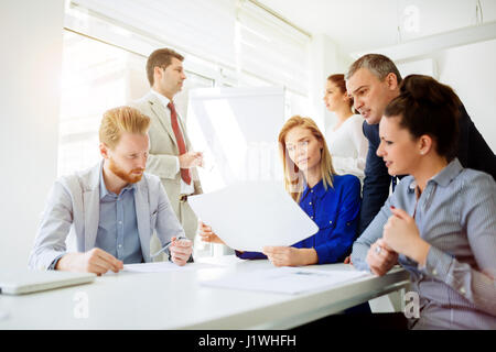 Businesspeople collaborating and talking through new ideas in office Stock Photo