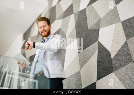 Succesful businessman checking time to be punctual Stock Photo