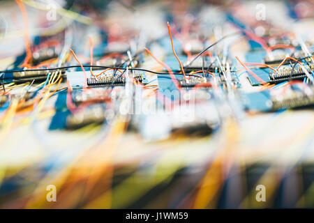 Many chips waiting to be soldered onto a board, representing mass production Stock Photo