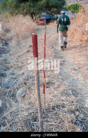 Stakes mark a minefield in a village near Cahora Bassa, Mozambique. The country was declared land mine free in 2015 Stock Photo