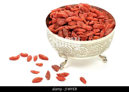 dried goji berries in a silver bowl isolated on white background Stock Photo