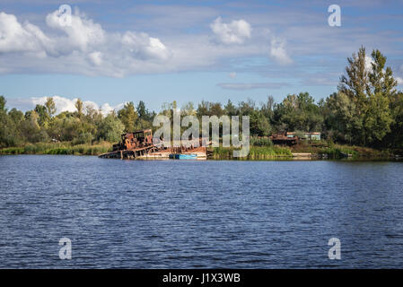 Ship wrecks around bank of backwater of Pripyat River in Chernobyl town, Chernobyl Nuclear Power Plant Zone of Alienation, Ukraine Stock Photo