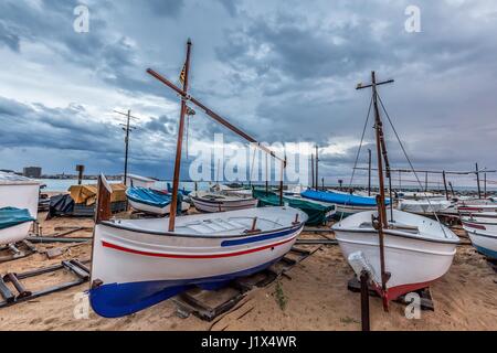 Small ficher boots on the beach in Palamos, Costa Brava in Spain Stock Photo