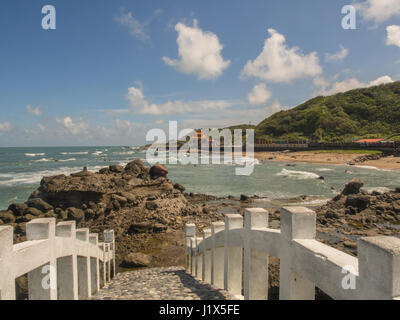 Shimen, Taiwan - October 03, 2016: A white bridge between the rocks and temple on the shore of the ocean in Shimen Art, northern Taiwan Stock Photo