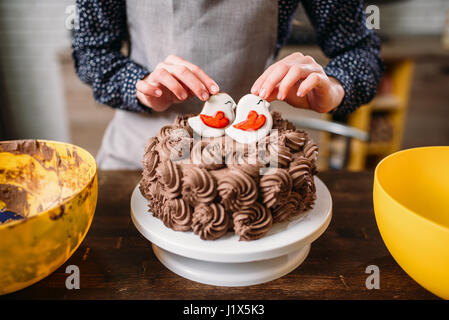 Decoration of chocolate cake with cookies in glaze. Homemade dessert Stock Photo