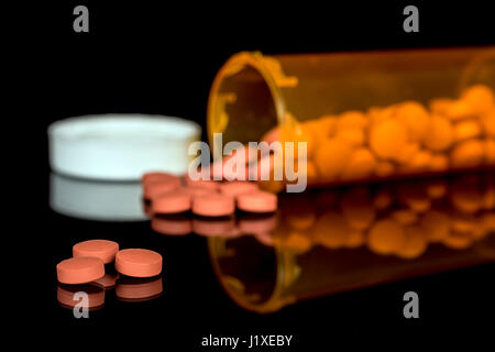 Pills have spilled out of a medicine bottle Stock Photo