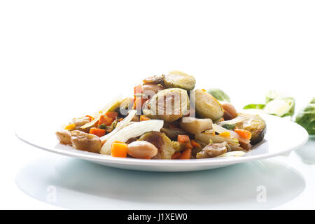 Brussels sprouts roasted with vegetables and beans Stock Photo