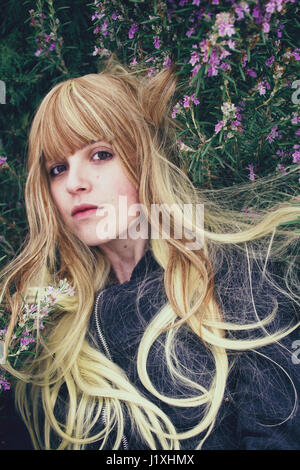 Young woman lying in a rosemary bush Stock Photo