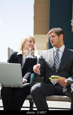 Two caucasian business people having a discussion outdoor Stock Photo