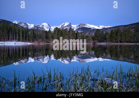 Pre dawn light on the Continental Divide and Sprague Lake located in Rocky Mountain National Park outside of Estes Park Colorado Stock Photo