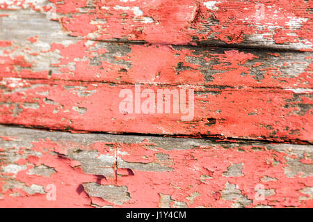 Wooden slats, with red peeling pain, close-up Stock Photo