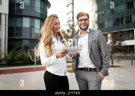 Business people commuting on street and talking Stock Photo