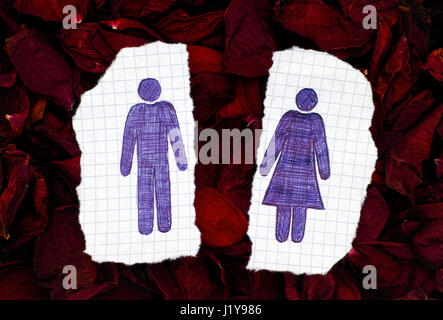 Two pieces of paper with hand drawn man and woman figures on dry petals of roses background. Doodle style. Stock Photo